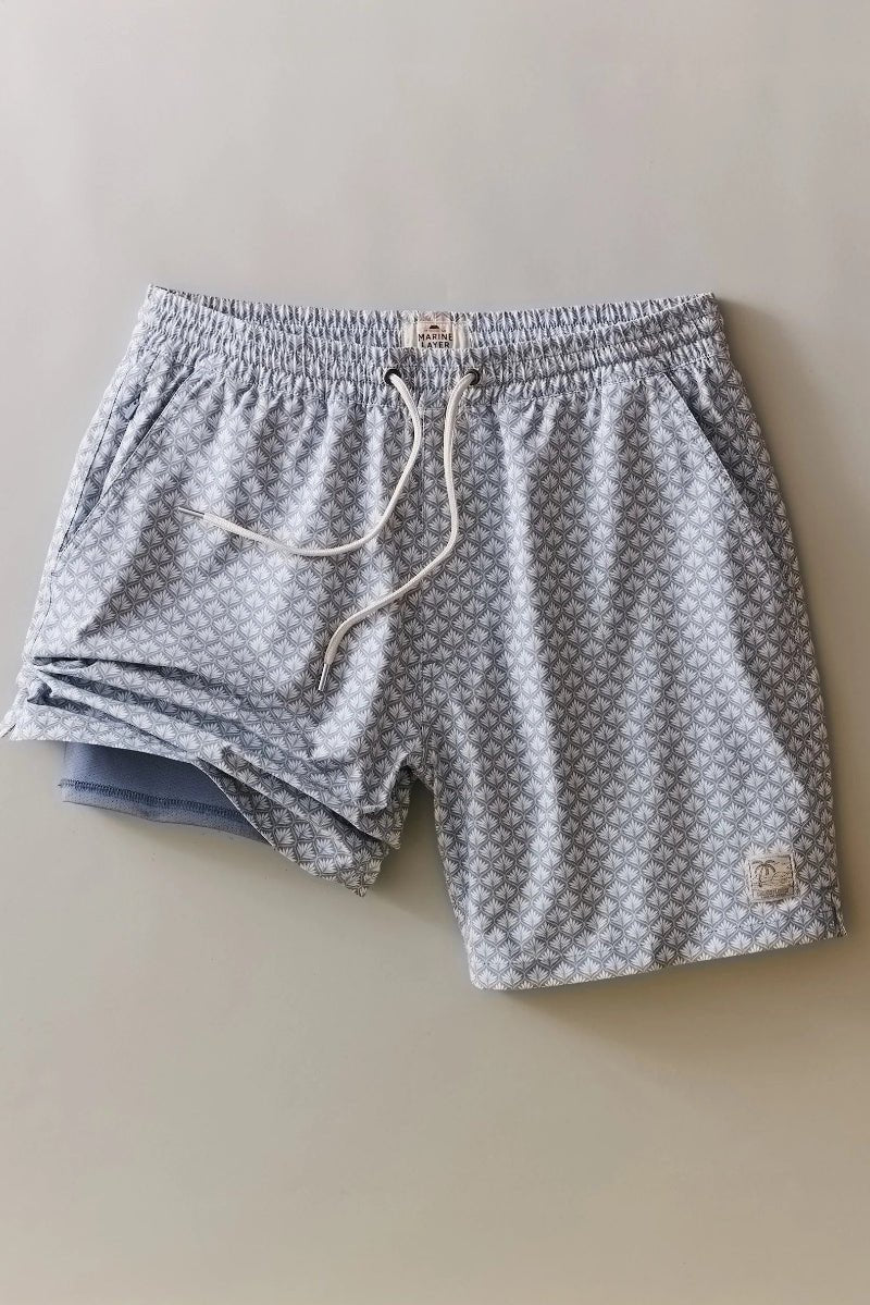 Gray patterned shorts with a drawstring on a beige background