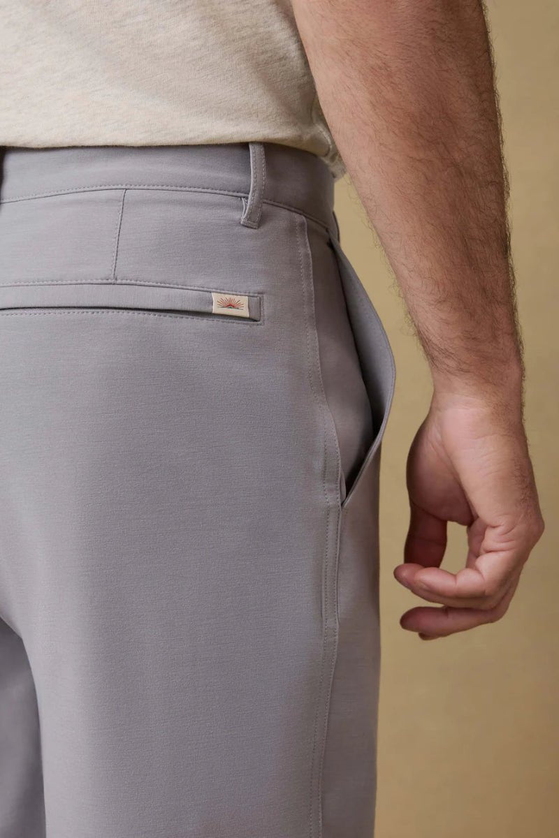 Gray pants with a brand logo on a beige background
