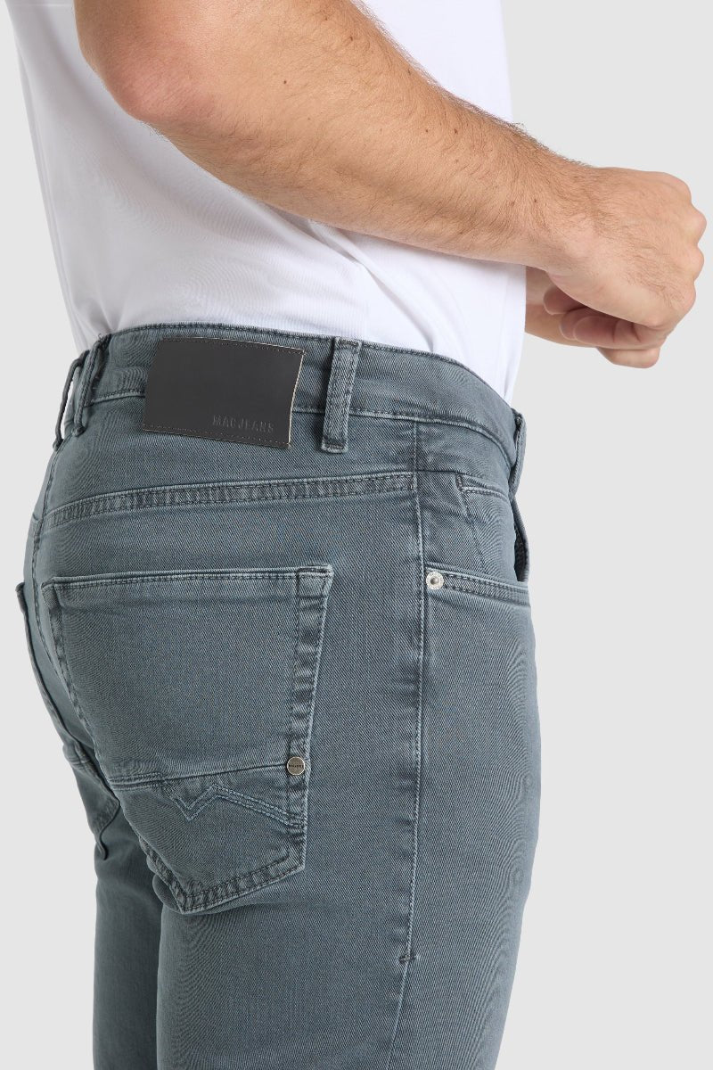 Person wearing light blue jeans with a white background