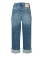 Blue jeans with a brand label on a white background
