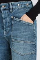 Close-up of blue jeans with a plain background