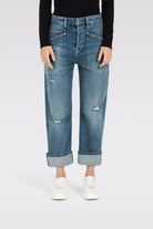 Blue jeans worn by a person on a white background