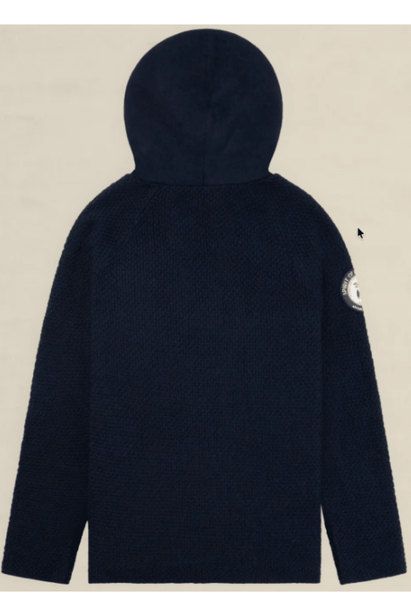 A dark navy blue textured hooded jacket shown from the back, featuring a circular patch on the left sleeve, set against a solid light beige background.