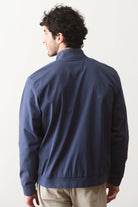 Man wearing a navy blue jacket on a white background