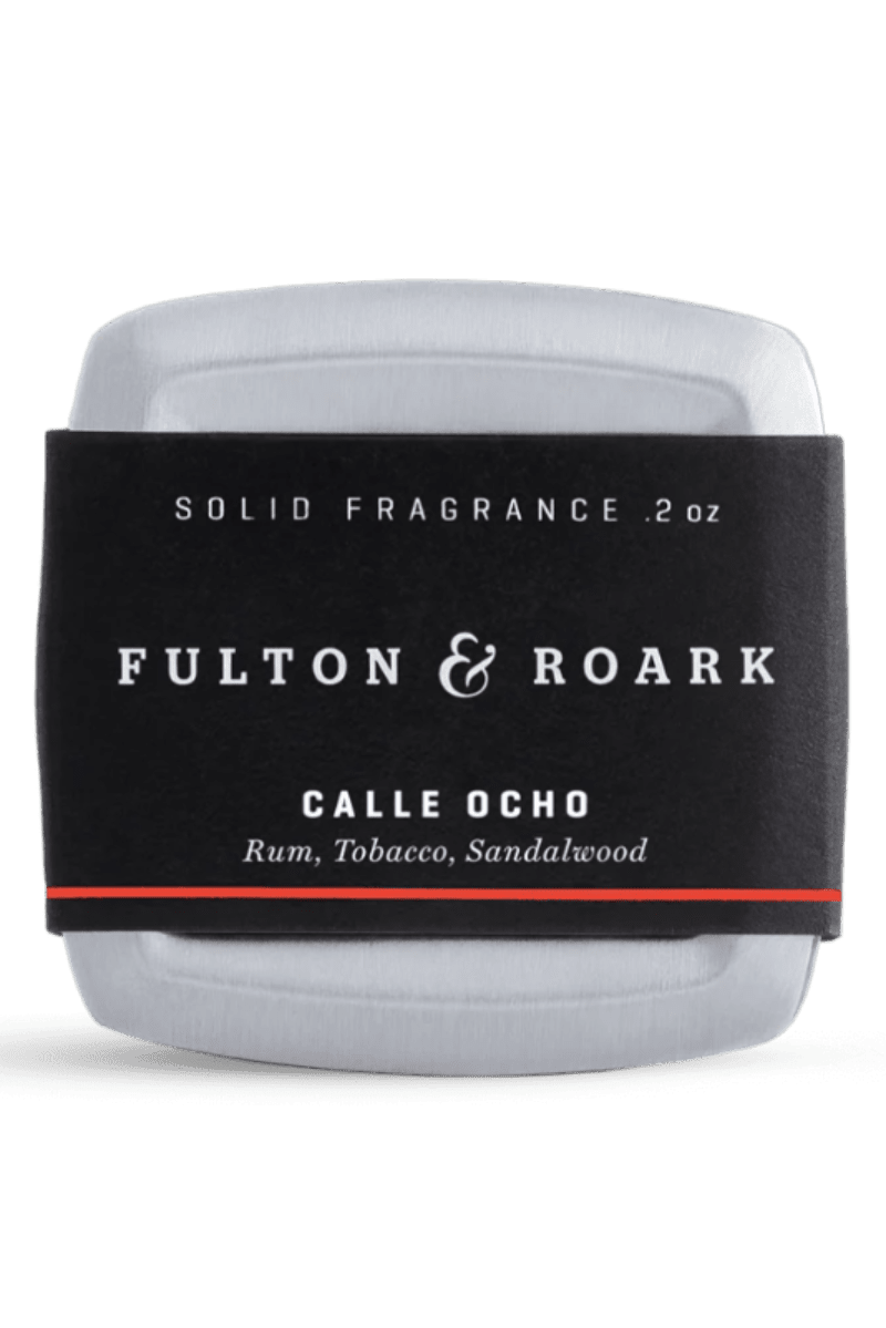 Solid fragrance container with 'Fulton & Roark' label on a white background