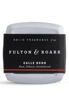 Solid fragrance container with 'Fulton & Roark' label on a white background