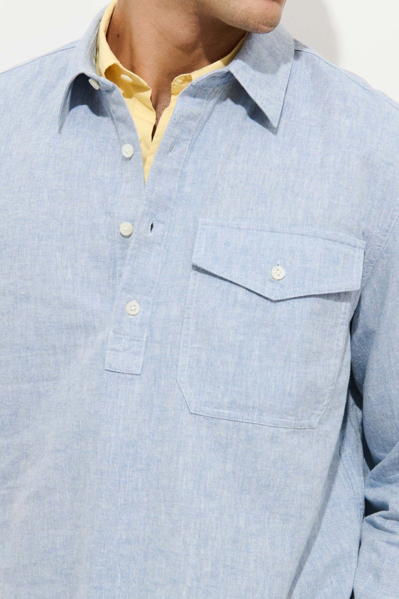 Light blue checkered shirt with a pocket and yellow collar peeking out