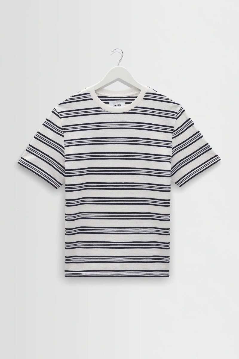 Striped t-shirt on a hanger against a white background