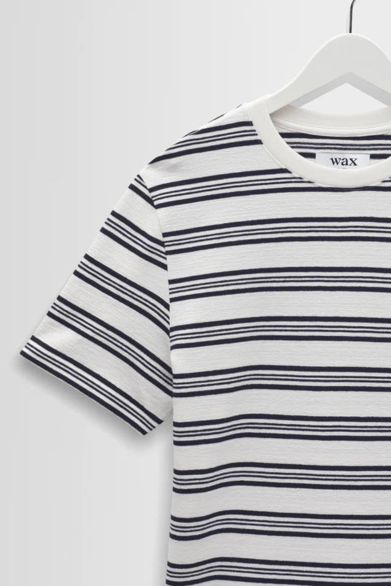 Striped t-shirt on a hanger with a white background