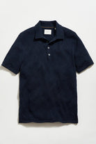 Navy blue textured polo shirt on a light gray background