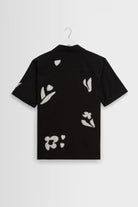 Black shirt with white floral patterns on a white background