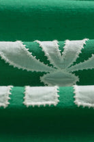 Close-up of green and white striped fabric with embroidered pattern