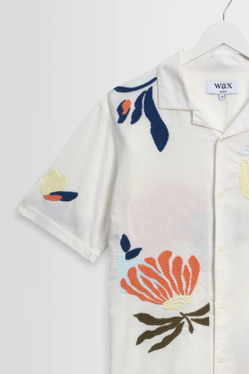 White shirt with floral embroidery on a white background
