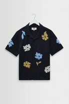 Black shirt with colorful floral patterns on a white background