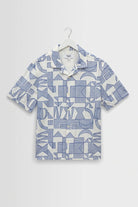 Short-sleeve shirt with geometric pattern on a hanger against a white background