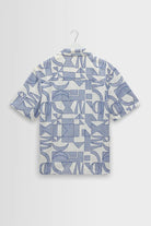 Short-sleeve shirt with geometric pattern on a hanger against a light gray background