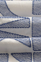 Close-up of blue geometric pattern on white fabric