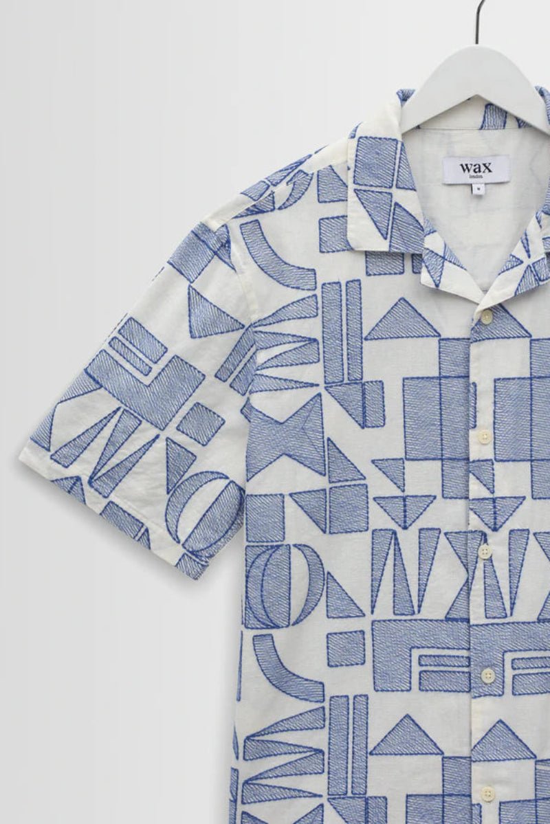 Short-sleeve shirt with blue geometric pattern on a white background
