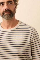 Man wearing a striped shirt against a plain background