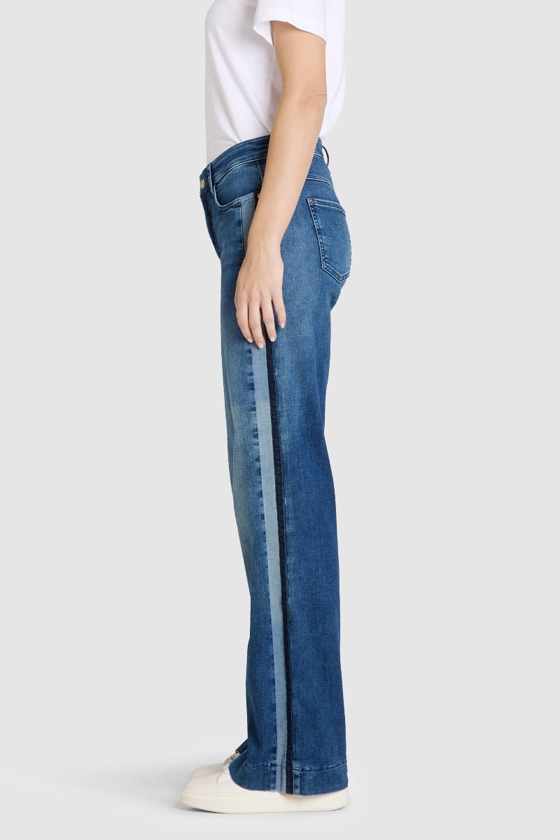 Person wearing blue jeans on a white background