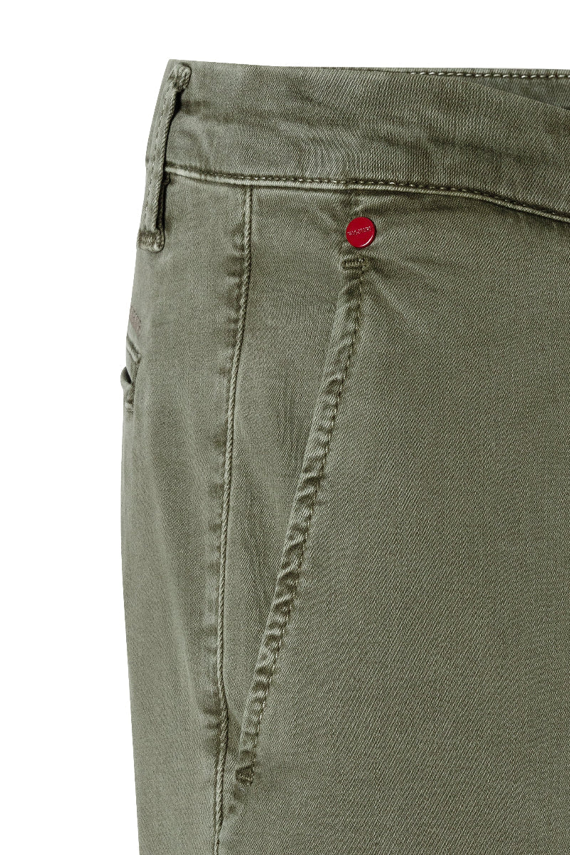 Close-up of green pants with a red button on a white background
