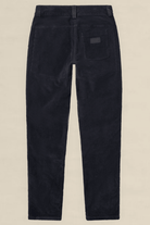 Rear view of dark navy corduroy trousers on a light beige background.
