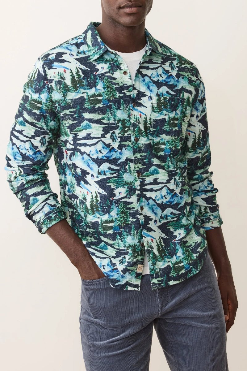Person wearing a patterned shirt with a neutral background