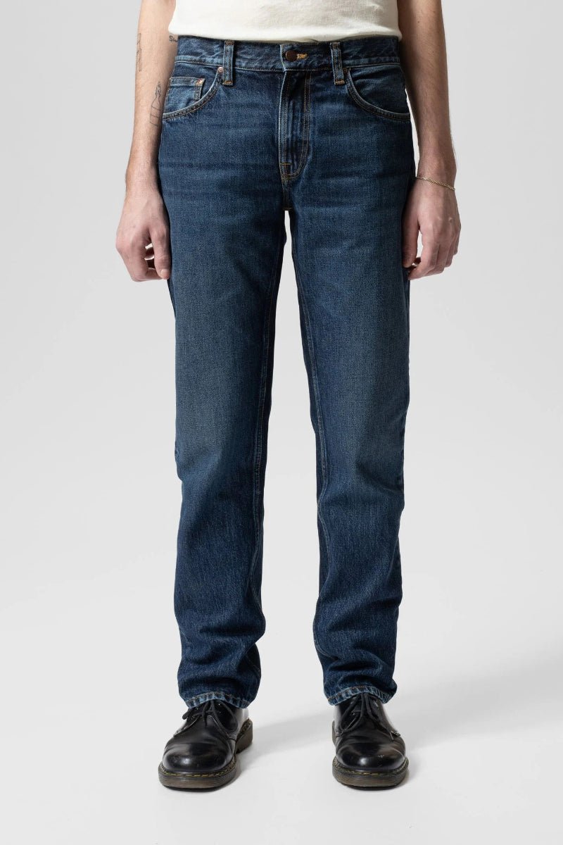 Person wearing blue jeans on a white background
