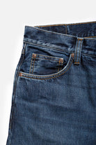 Close-up of blue jeans with a white background