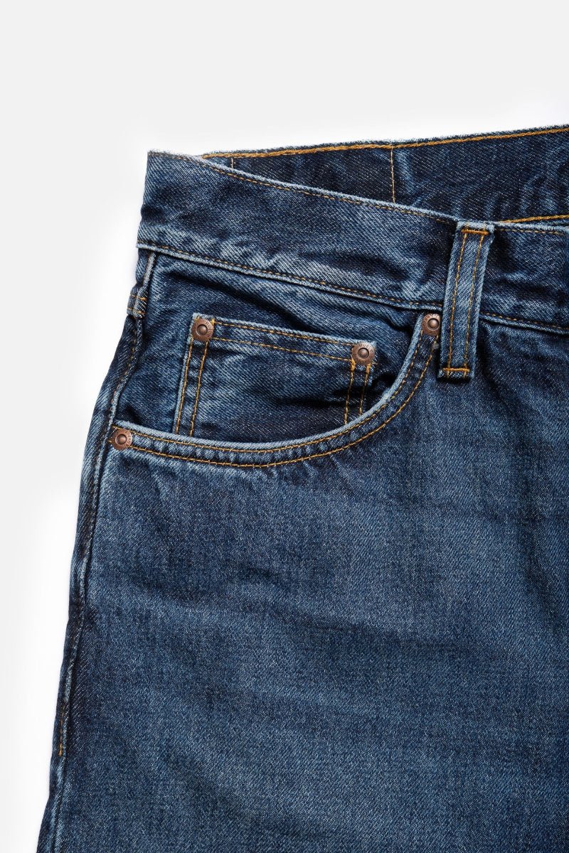 Close-up of blue jeans with a white background