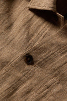 Close-up of a brown textured fabric with a button