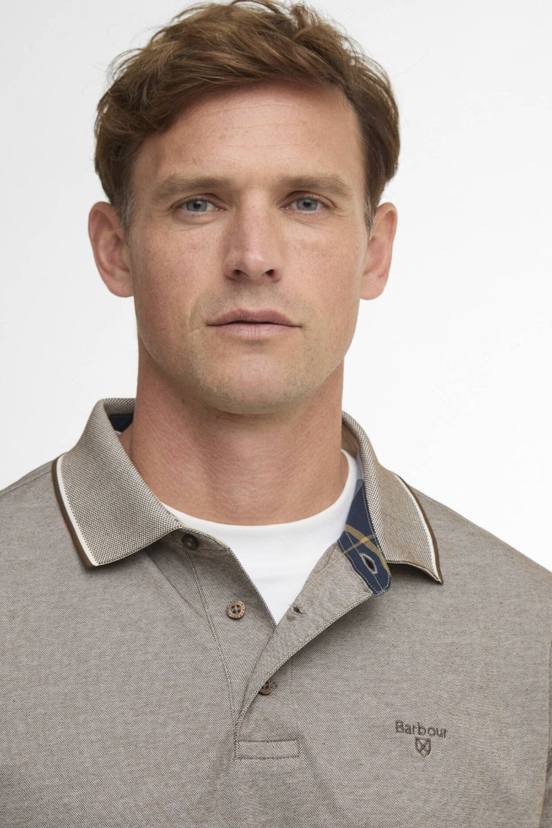 Man wearing a gray polo shirt with a collar, featuring the Barbour brand logo.