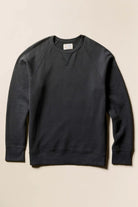 Black sweatshirt on a beige background