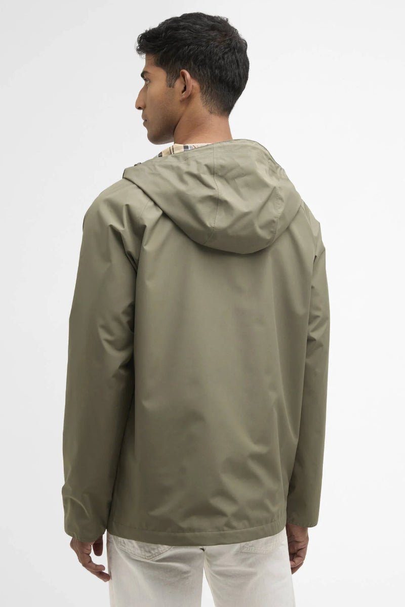 Man wearing a green raincoat on a white background
