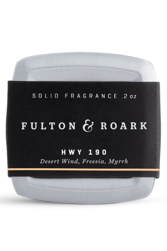Solid fragrance container with 'Fulton & Roark' label on a white background