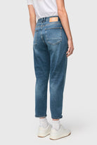 Person wearing blue jeans on a white background