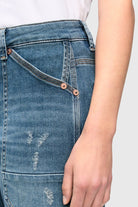 Close-up of blue jeans with a white background