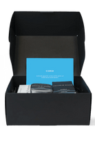 Black box with a blue card and other items on a white background