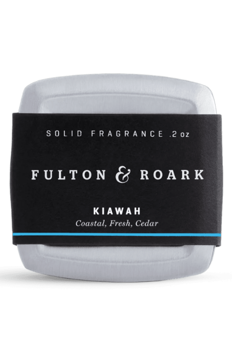 Solid fragrance stick by Fulton & Roark with black label on a white background