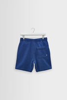 Blue shorts on a hanger against a white background