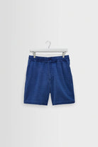 Blue shorts on a hanger against a white background