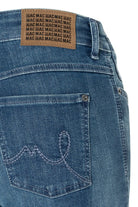 Close-up of blue jeans with a brand label on the back pocket.