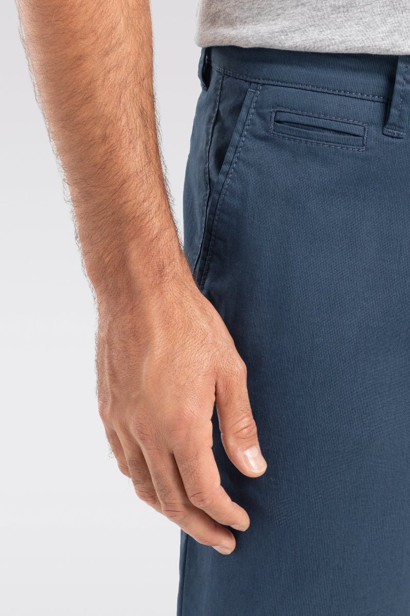 Navy blue pants worn by a person on a white background