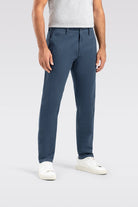 Person wearing blue pants on a light gray background