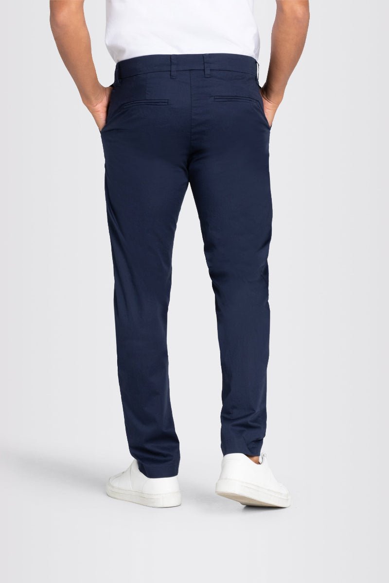 Navy blue pants worn by a person on a white background
