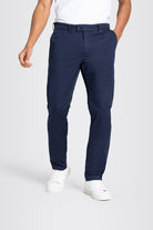 Person wearing navy pants and white shoes on a light gray background