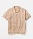 Beige short-sleeve polo shirt on a light beige background