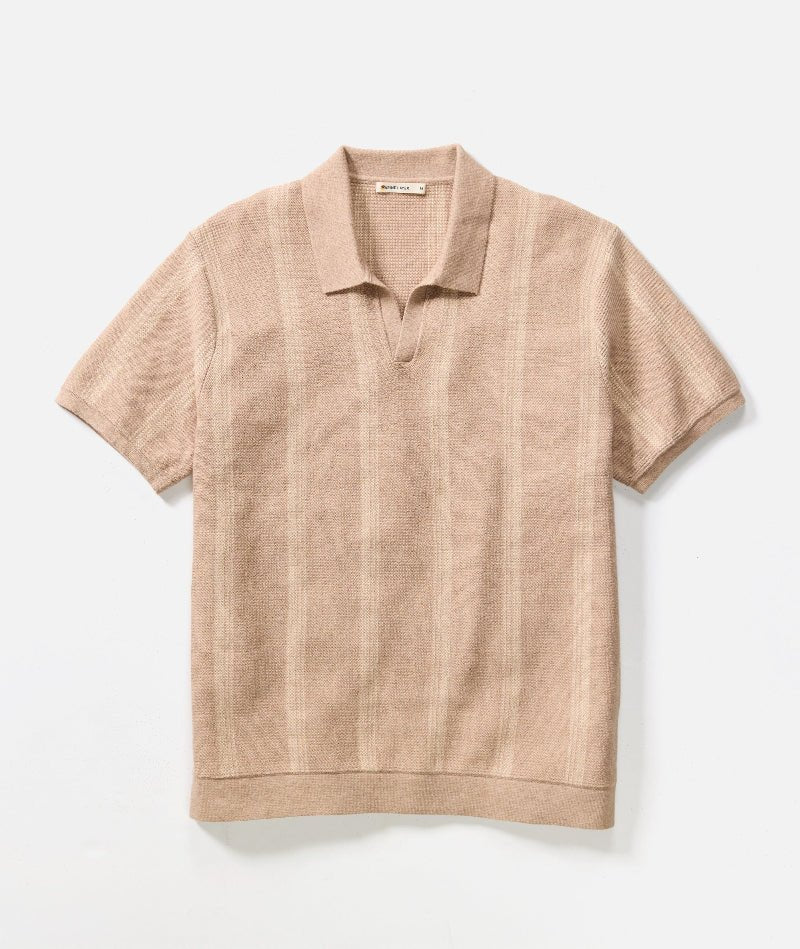 Beige short-sleeve polo shirt on a light beige background