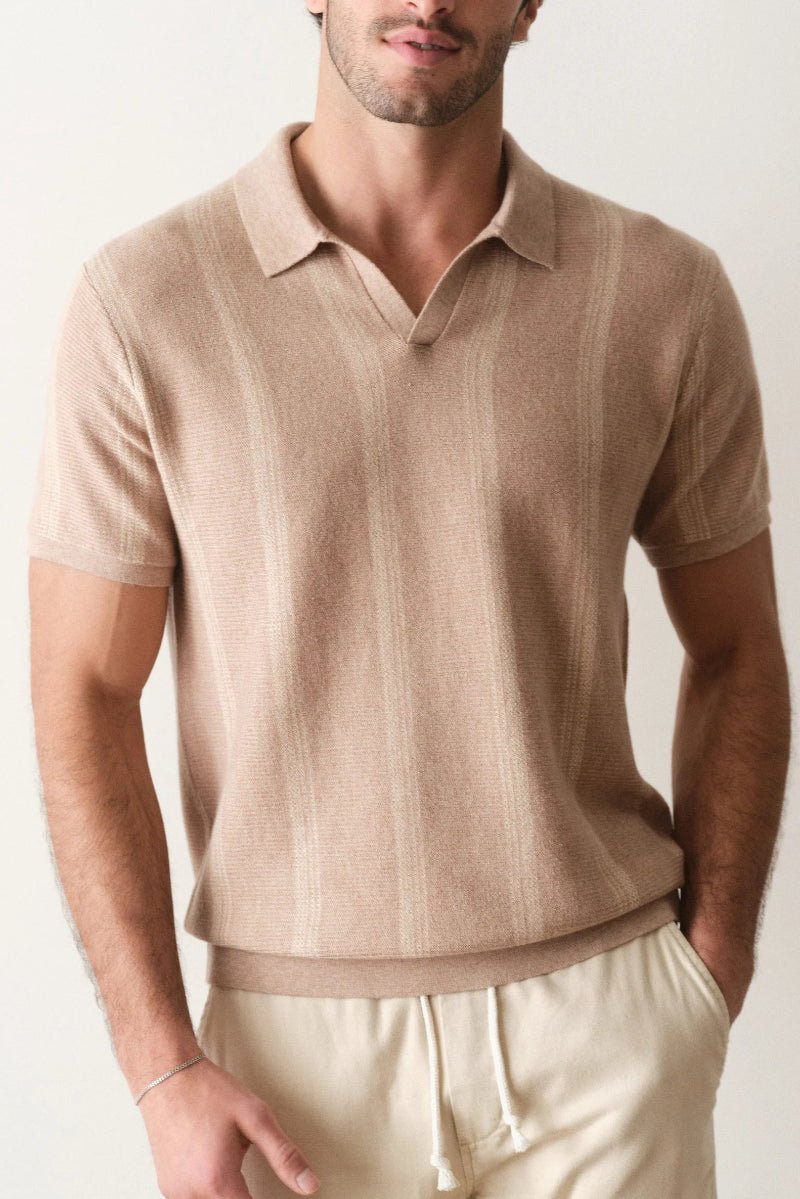 Man wearing a beige short-sleeve polo shirt against a plain background