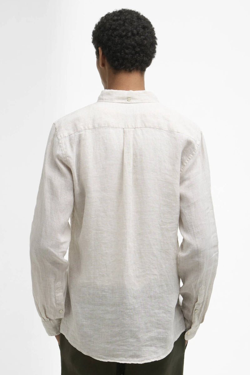 Person wearing a light-colored shirt on a white background